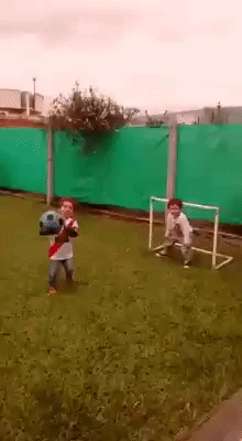 Child reaction. Two kids playing football