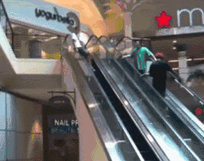 Cool kid sliding down an escalator railing