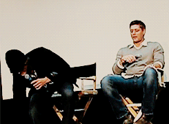 Jared and Jensen highfiving with their feet. ;-