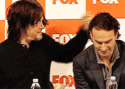 Norman Reedus gives Andrew Lincoln a kiss during press conference