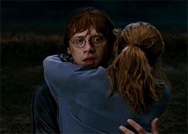 Ron looks so surprised at first then he happily accepts the fact that she's hugging him