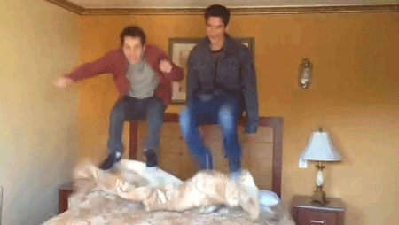 tyler posey and dylan o'brien jumping on a bed