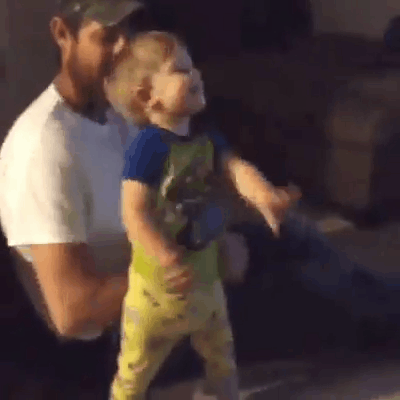 Dad and son dance together
